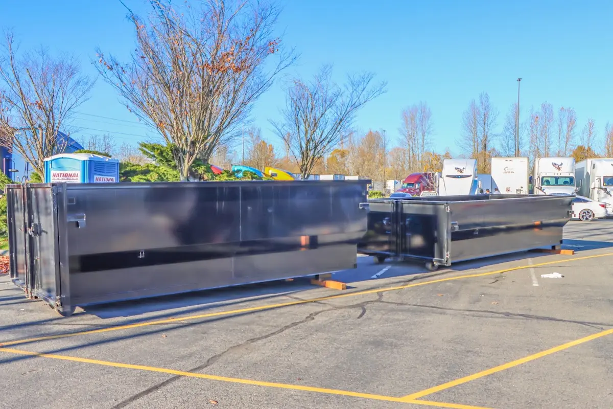 Professional dumpster rental service with roll-off container on residential driveway in Airway Heights